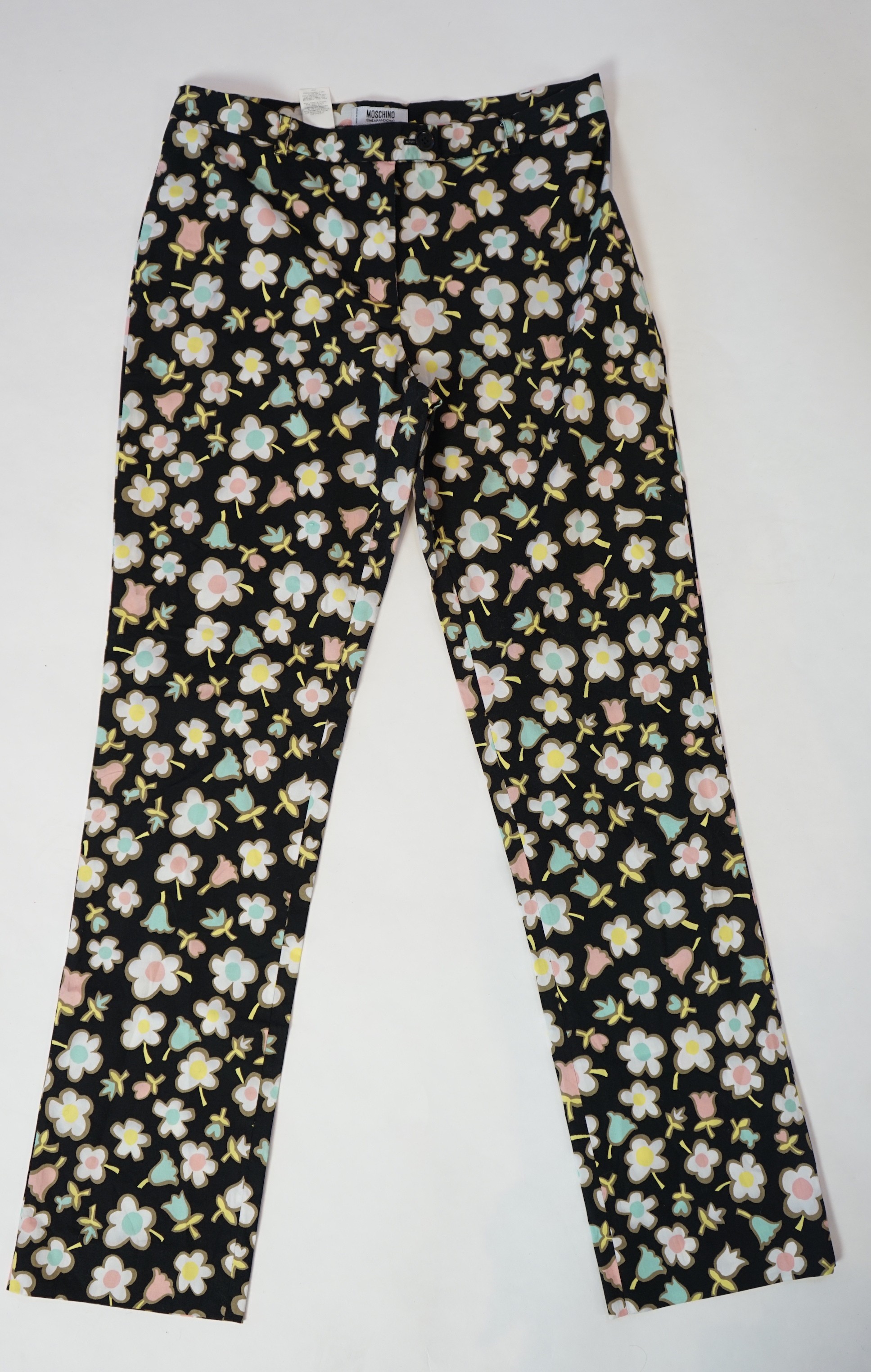 A Moschino lady's long blue and red jacket, a cream cotton embellished blazer and a cotton pair of floral trousers, blue and red jacket size 14, cream blazer size 12, trousers size: 10